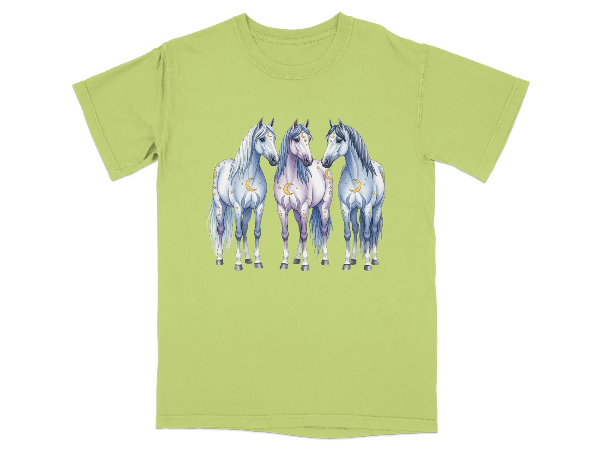 Three stylized horses with moon and star accents stand together on a light green t-shirt.
