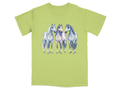 Three stylized horses with moon and star accents stand together on a light green t-shirt.
