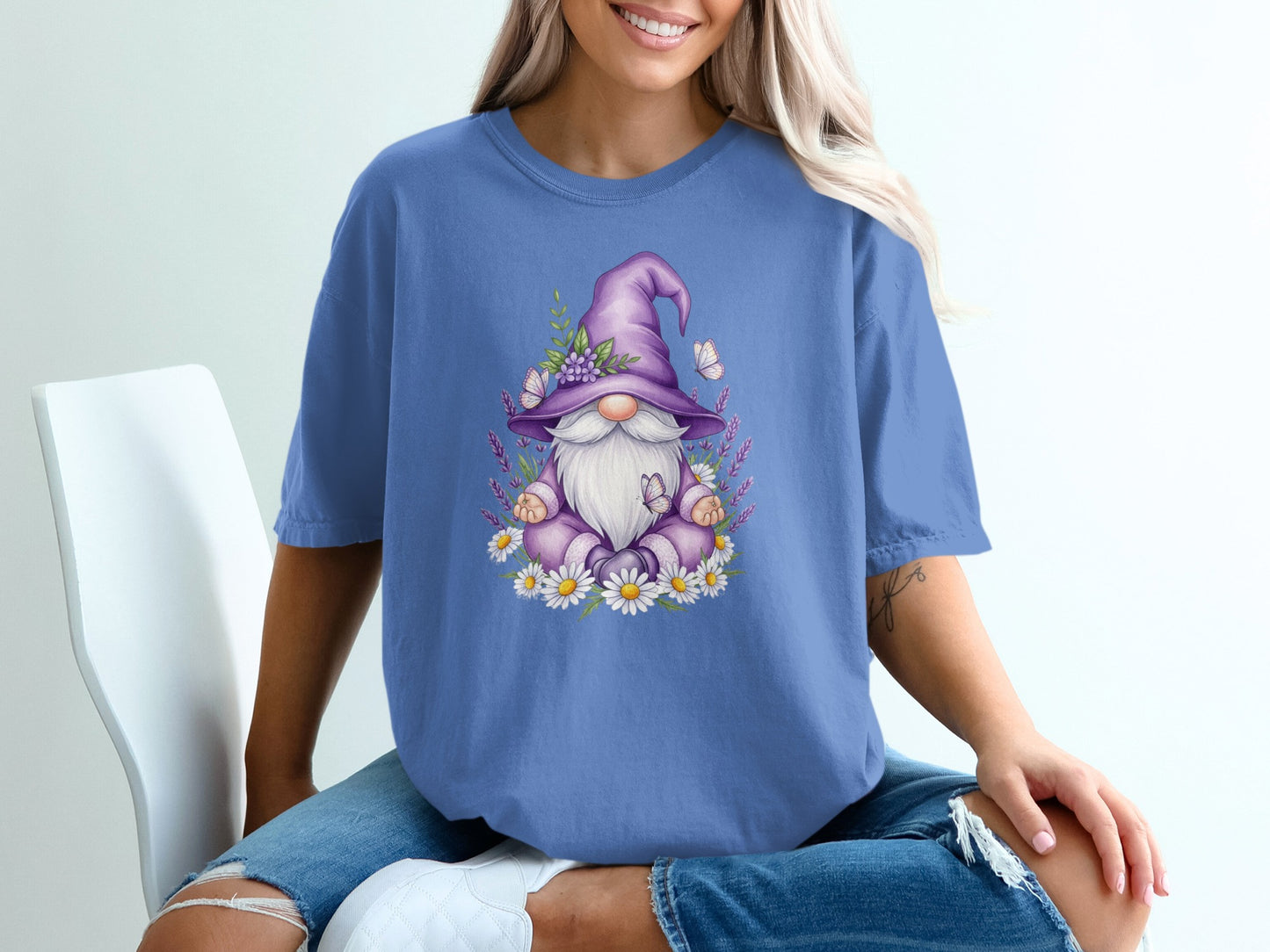 Purple gnome with flowers and butterflies on a t-shirt.