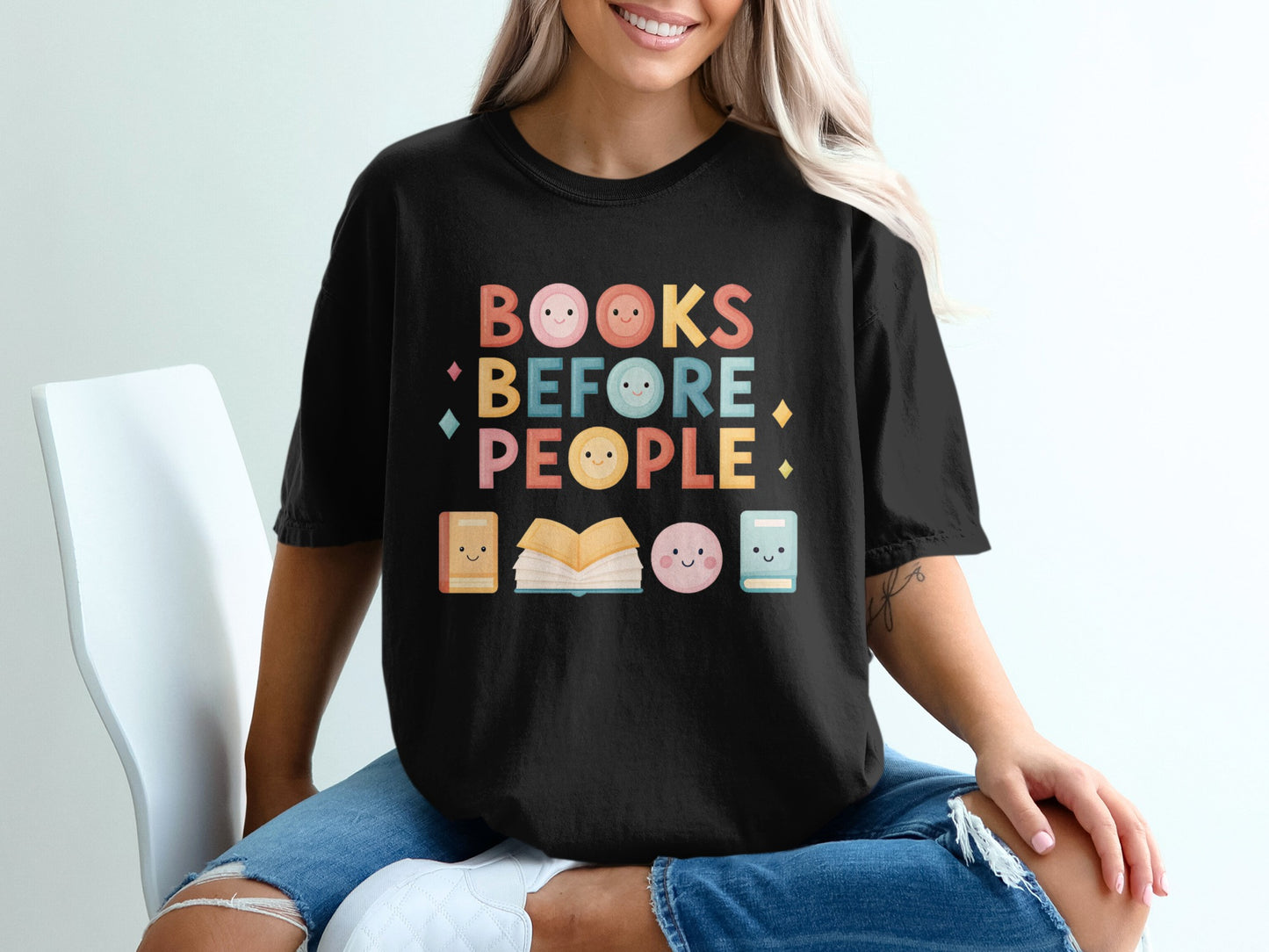 Black t-shirt with "Books Before People" text and cute book and face graphics.