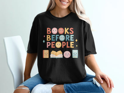 Black t-shirt with "Books Before People" text and cute book and face graphics.