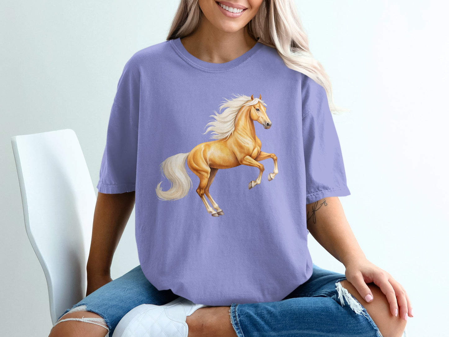 Loose-fit purple t-shirt with a golden horse illustration.