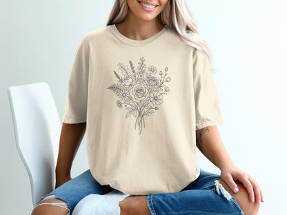 Cream t-shirt with a delicate line drawing of a floral bouquet.