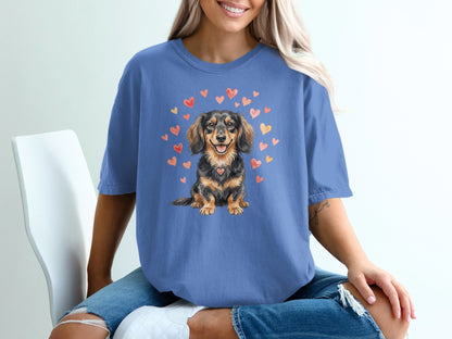 Blue t-shirt with a dachshund illustration surrounded by hearts.