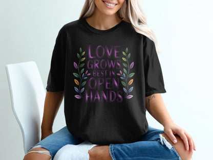 Black t-shirt with "Love Grows Best in Open Hands" text and floral design.