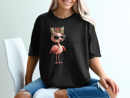 Black t-shirt with a flamingo graphic wearing sunglasses and a leopard print bow.