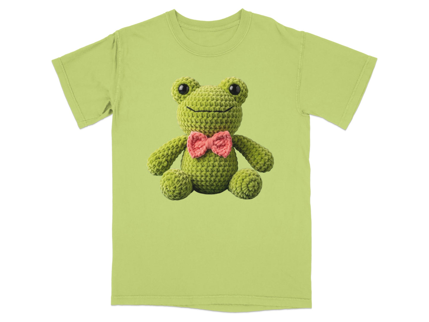 Green t-shirt featuring a crocheted frog with a pink bow tie.