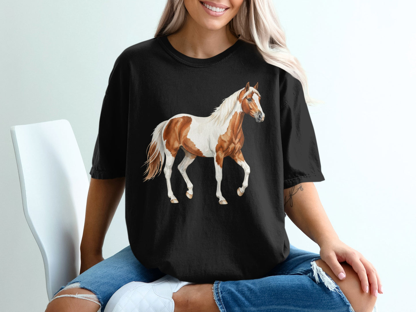Black t-shirt with a brown and white horse illustration.