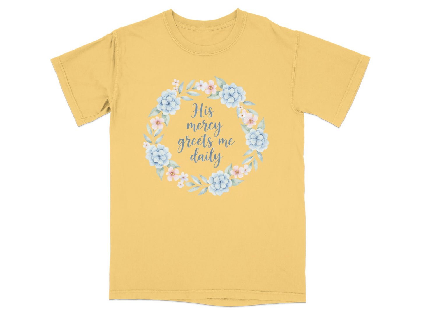 Yellow t-shirt with floral wreath and text "His mercy greets me daily."
