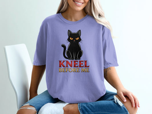 Purple t-shirt with a black cat and "Kneel Before Me" text.