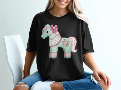 Black t-shirt with a pastel patchwork unicorn graphic.