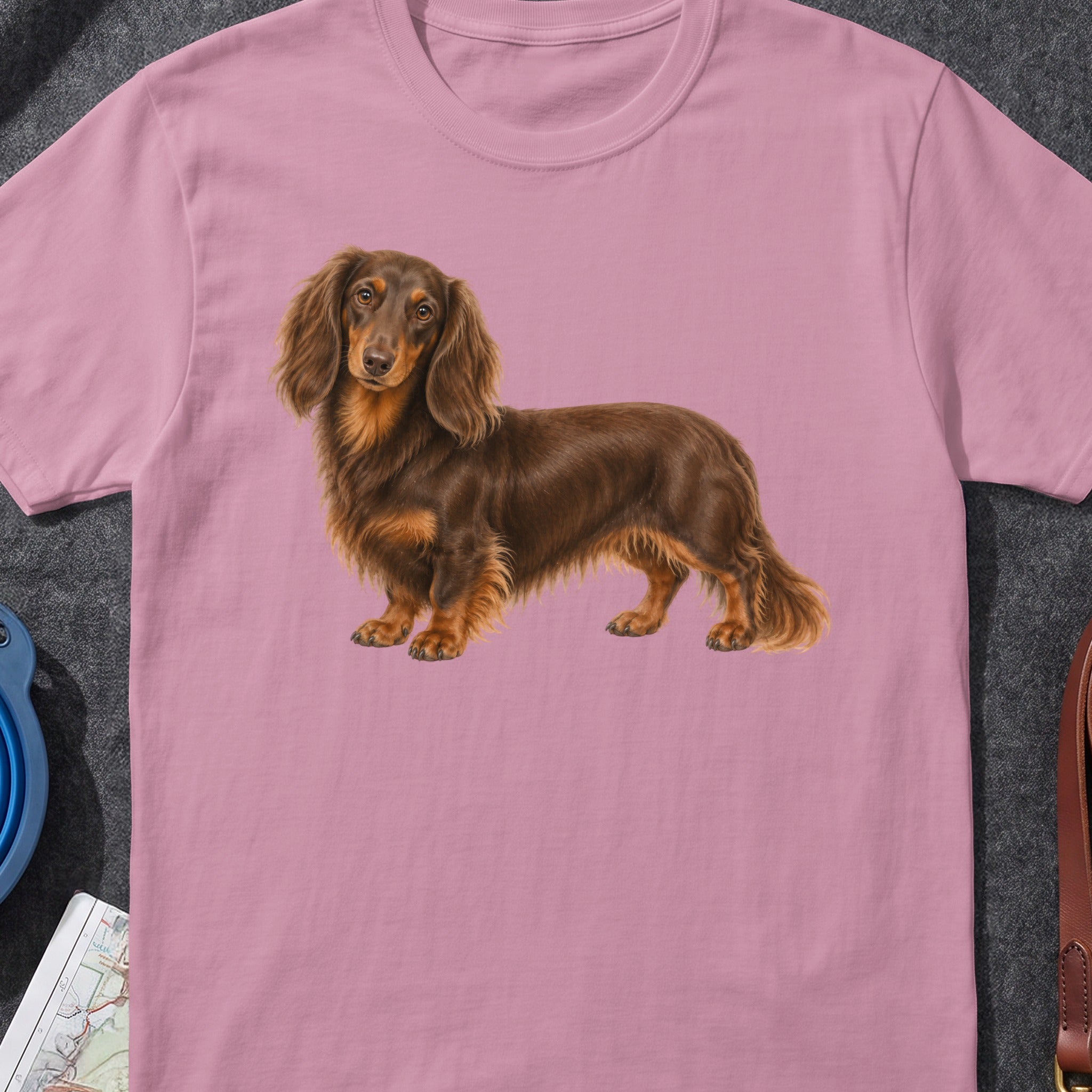 Long-haired brown dachshund illustration on a pink t-shirt.