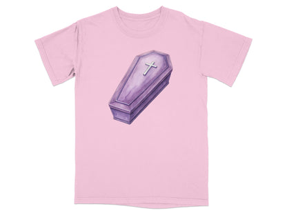 Purple coffin graphic with a silver cross on a light pink t-shirt.