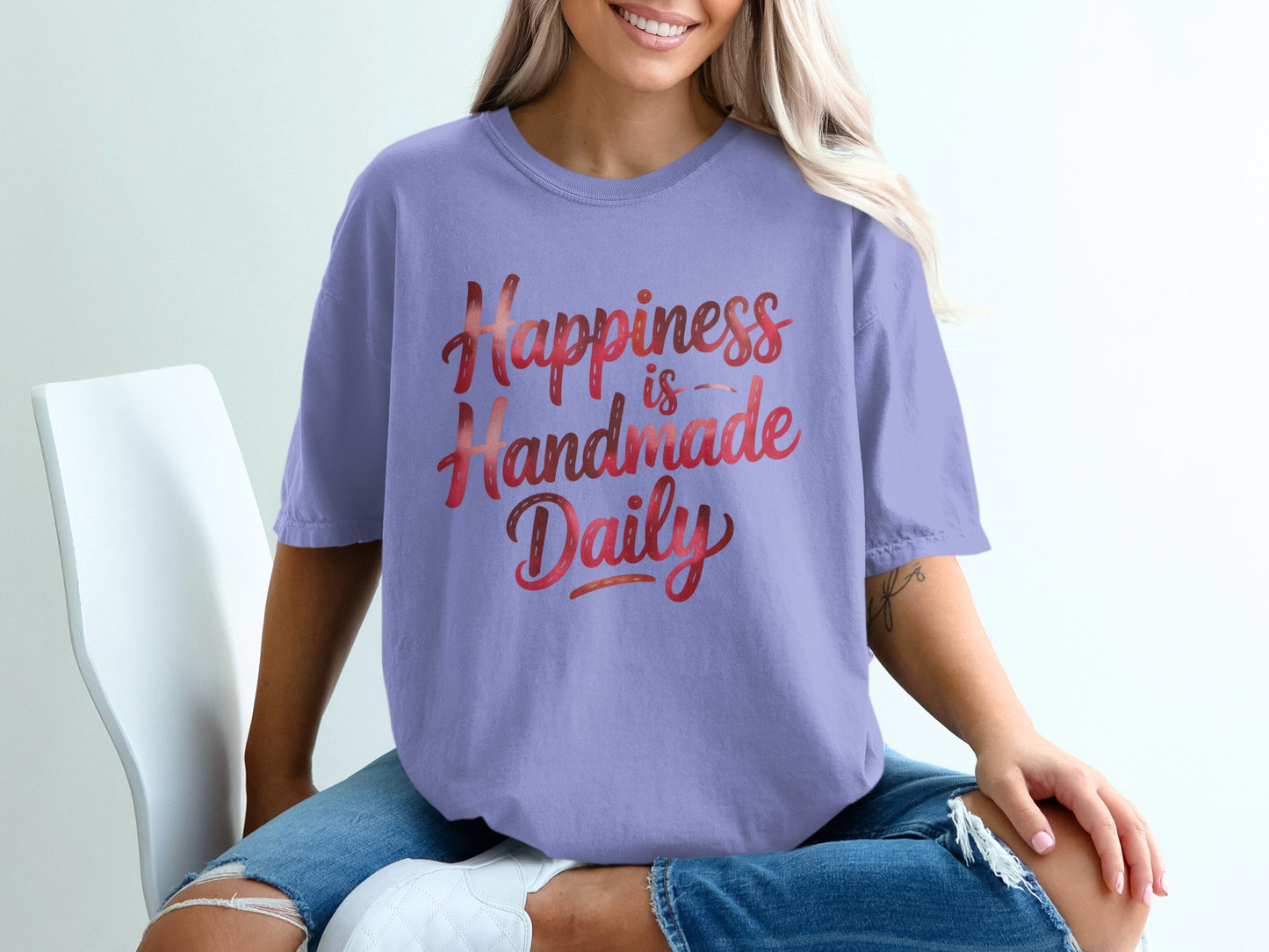 Lavender t-shirt with "Happiness is Handmade Daily" gradient text.