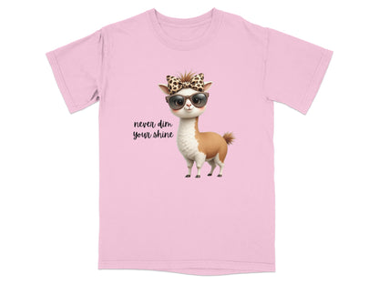 Pink t-shirt with llama wearing sunglasses and bow, text "never dim your shine".