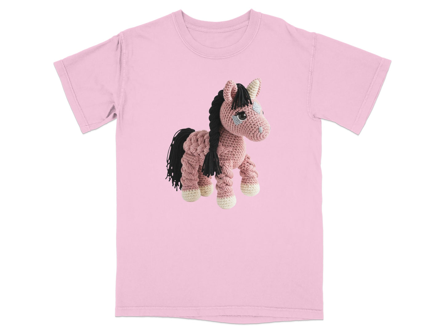 Crocheted pink horse with black mane and tail on a pink t-shirt.