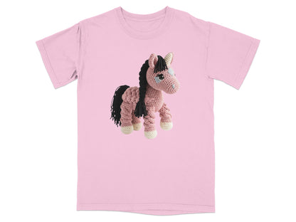 Crocheted pink horse with black mane and tail on a pink t-shirt.