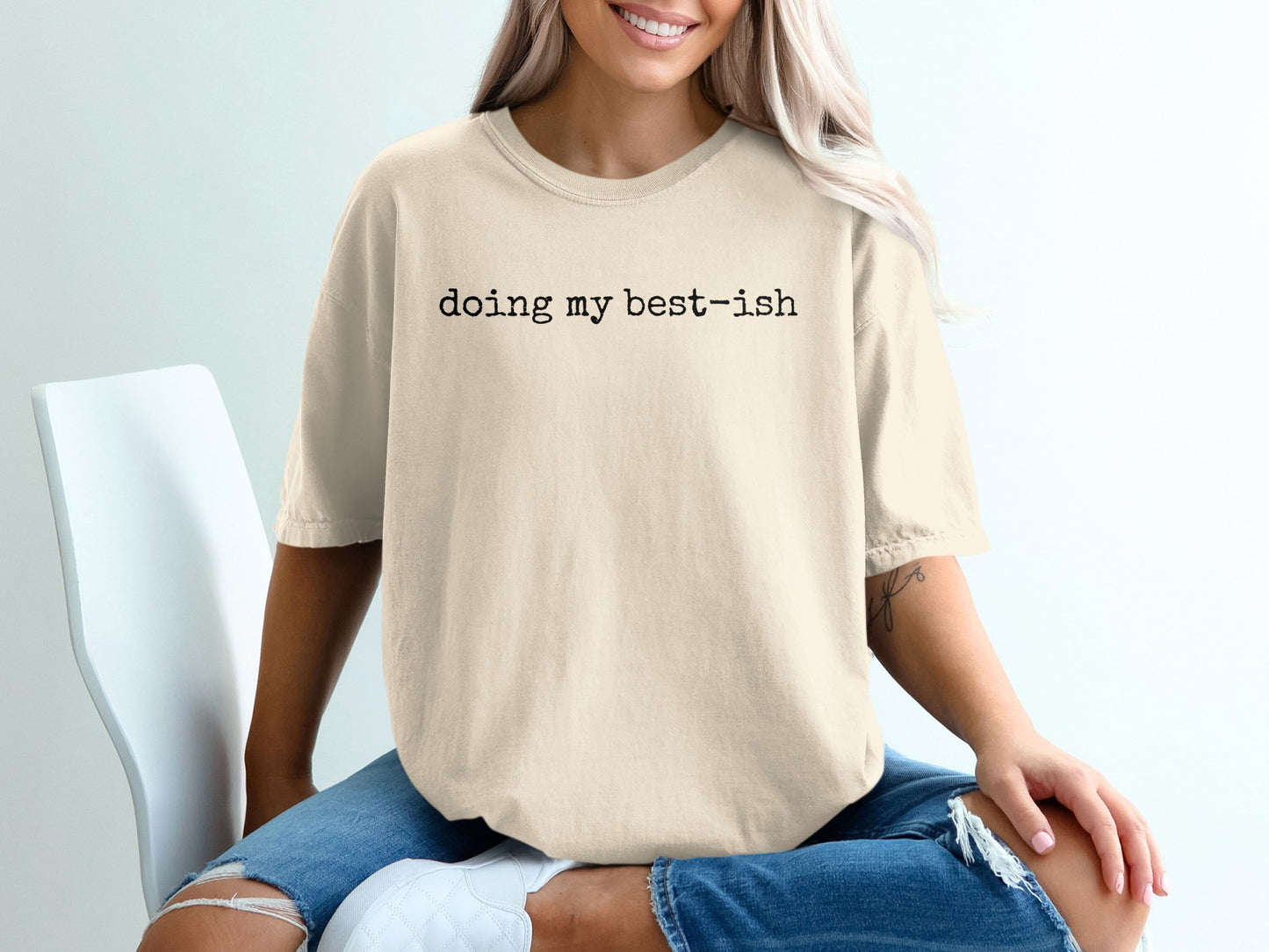 Cream t-shirt with black text "doing my best-ish" worn by a person.