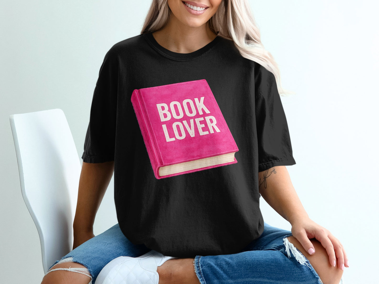 Black t-shirt with a pink book graphic reading "BOOK LOVER".