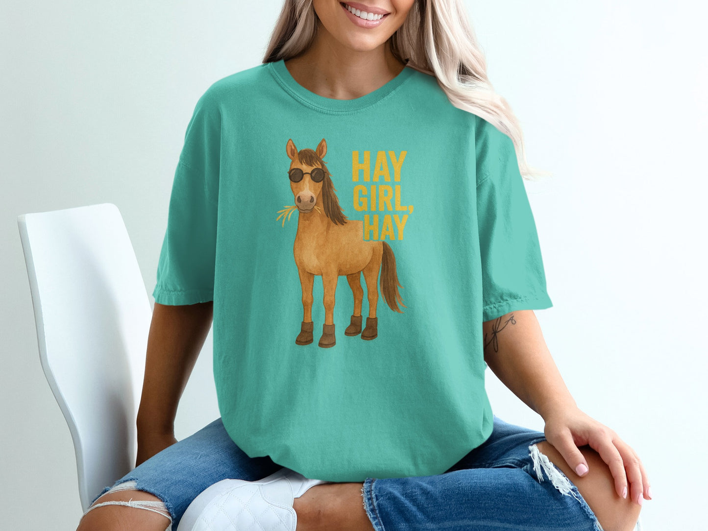 Teal t-shirt with sunglasses-wearing horse and "Hay Girl Hay" text.