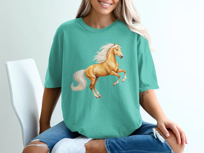 Turquoise t-shirt with a leaping golden horse graphic.
