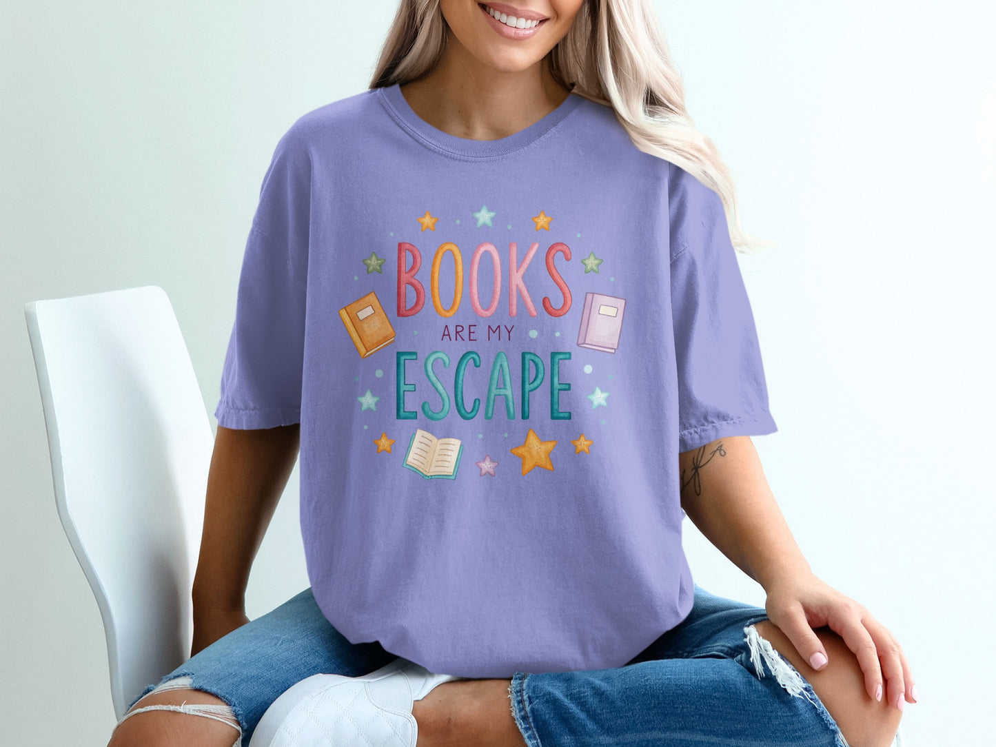 Lavender t-shirt with "Books are my escape" text and book illustrations.
