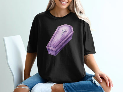 Black t-shirt with a purple coffin graphic and a silver cross.
