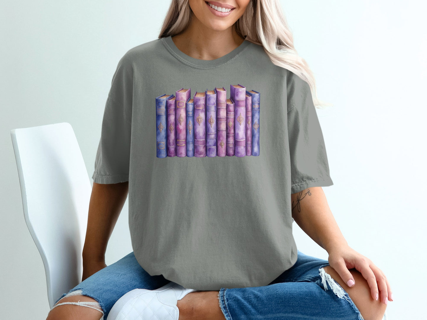 Watercolor illustration of a stack of vintage books with purple and gold spines.