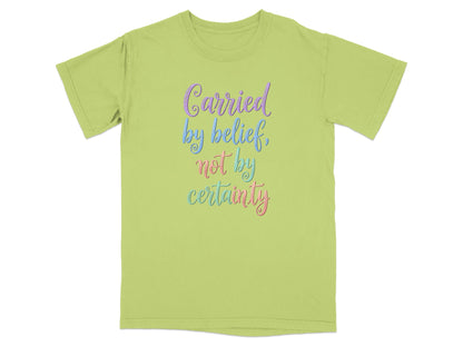 Lime green t-shirt with "Carried by belief, not by certainty" text.