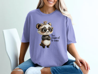 Purple t-shirt with a cartoon panda wearing glasses and a bow, saying "Too original to copy."