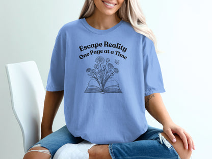 Blue t-shirt with "Escape Reality One Page at a Time" and open book with flowers.