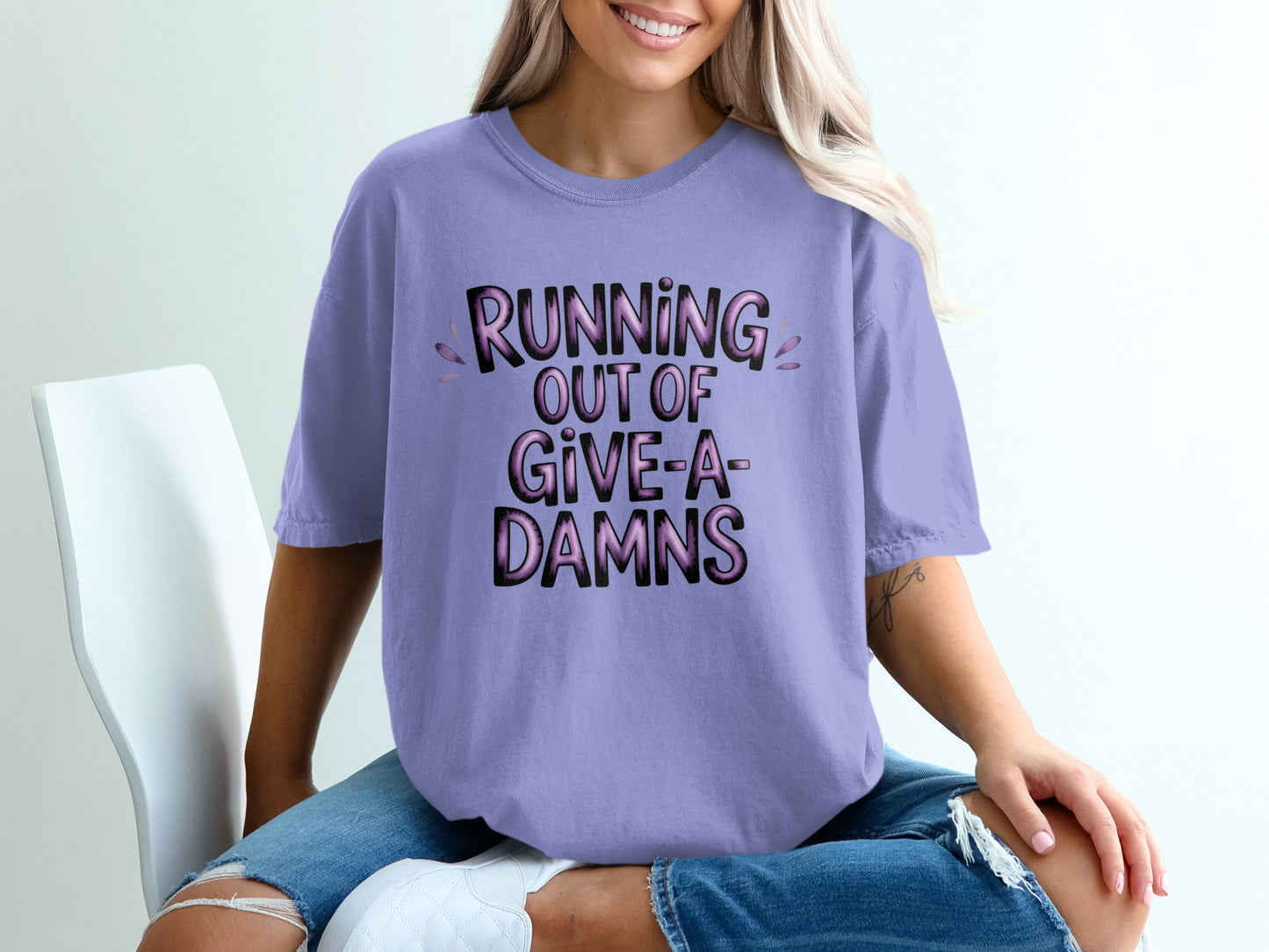 Lavender t-shirt with "RUNNING OUT OF GIVE-A-DAMNS" text.