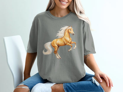 Golden horse rearing on hind legs on a grey t-shirt.