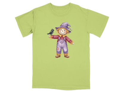 Scarecrow wearing a purple hat and plaid shirt holds a black bird.