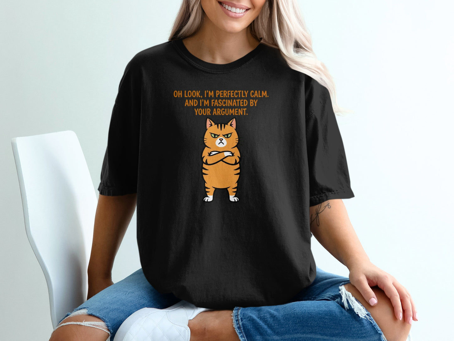 Black t-shirt with an angry cartoon cat and text "Oh look, I'm perfectly calm."