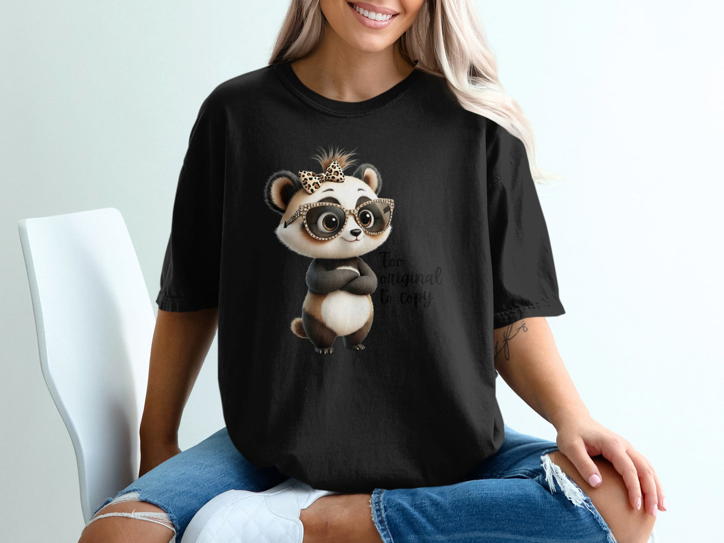 Black t-shirt with cartoon panda wearing glasses and a bow, text "too original to copy."
