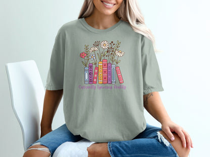T-shirt with books and flowers, reading "Currently Ignoring Reality".
