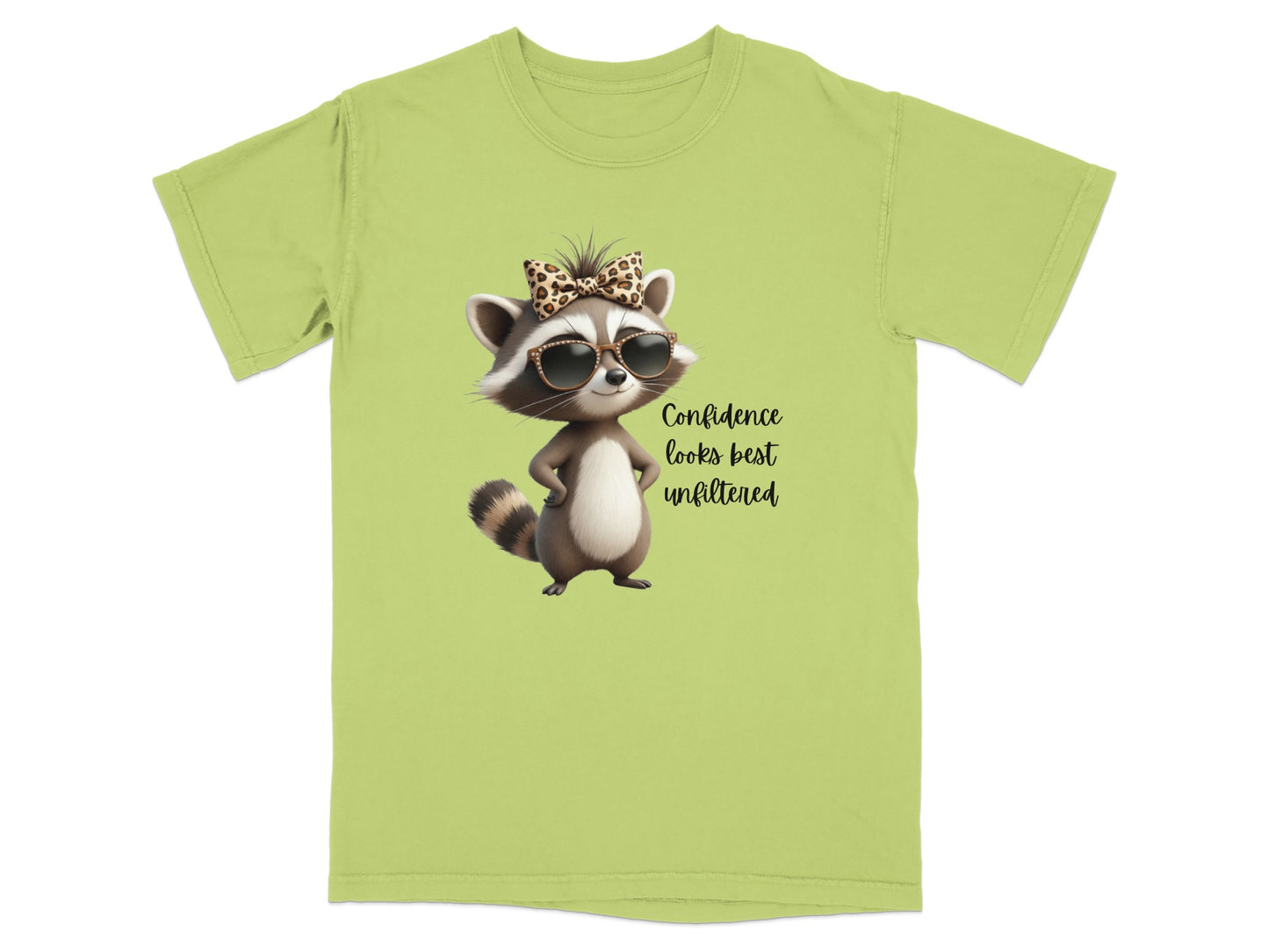 Green t-shirt with a raccoon wearing sunglasses and a bow, with text "Confidence looks best unfiltered".