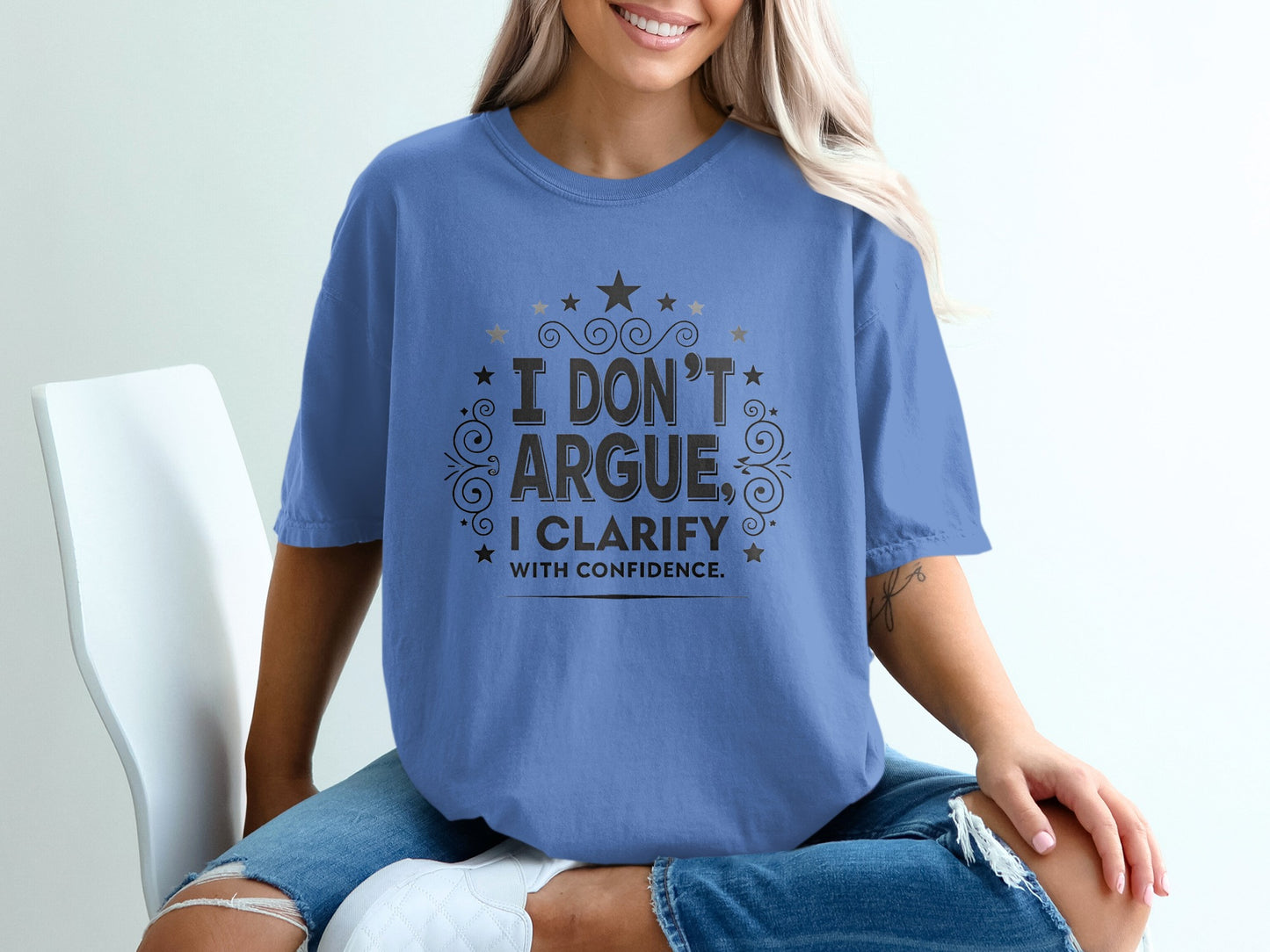 Blue t-shirt with "I DON'T ARGUE, I CLARIFY WITH CONFIDENCE." text.