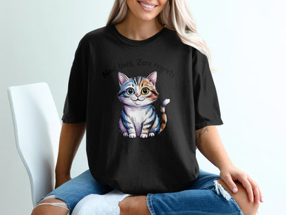 Black t-shirt with a cartoon cat and text "Nine lives, zero regrets".