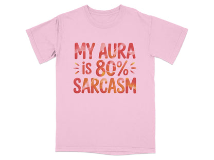 Pink t-shirt with "MY AURA IS 80% SARCASM" text in colorful gradient.