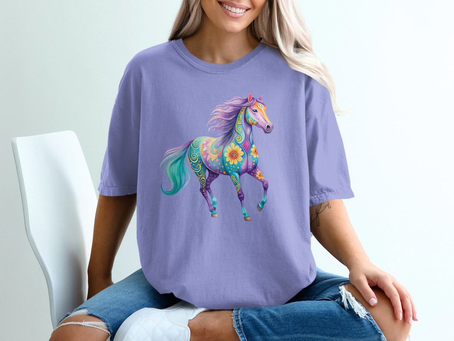 Purple t-shirt with a colorful, patterned unicorn or horse graphic.