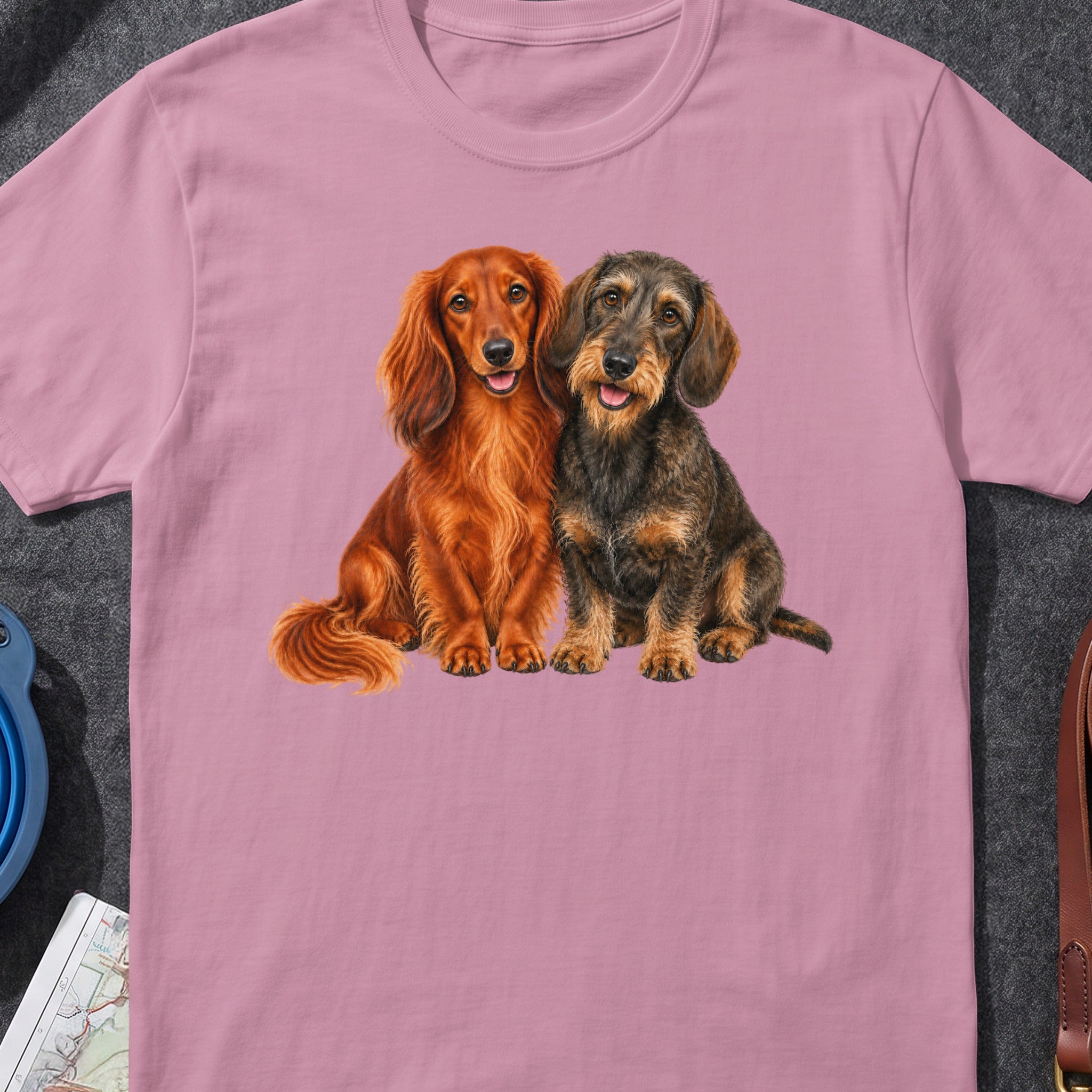 Pink t-shirt featuring a close-up print of two cheerful dachshund dogs.