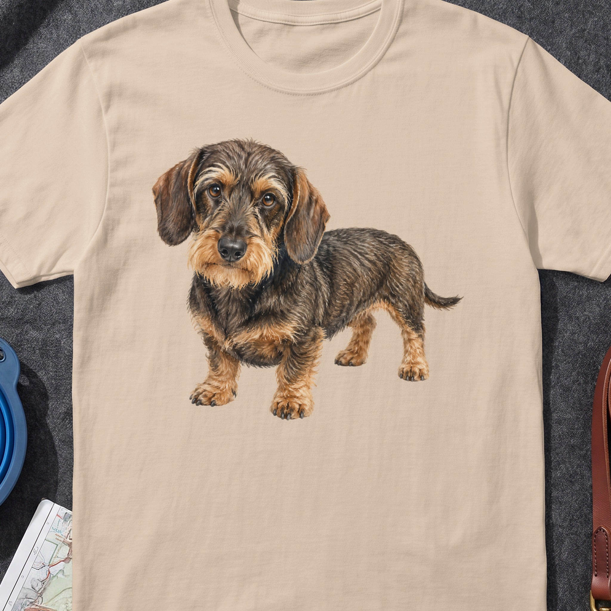 Illustration of a wirehaired dachshund on a tan t-shirt.