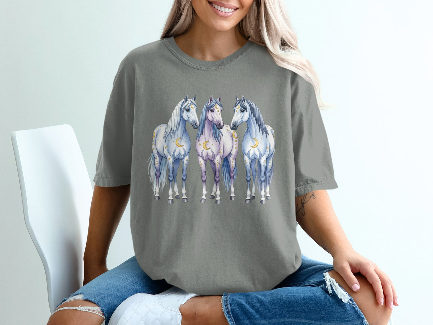 Three horses with celestial motifs on a gray t-shirt.