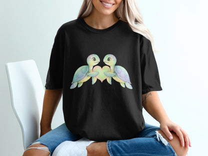 Two cartoon turtles with pastel shells form a heart shape.