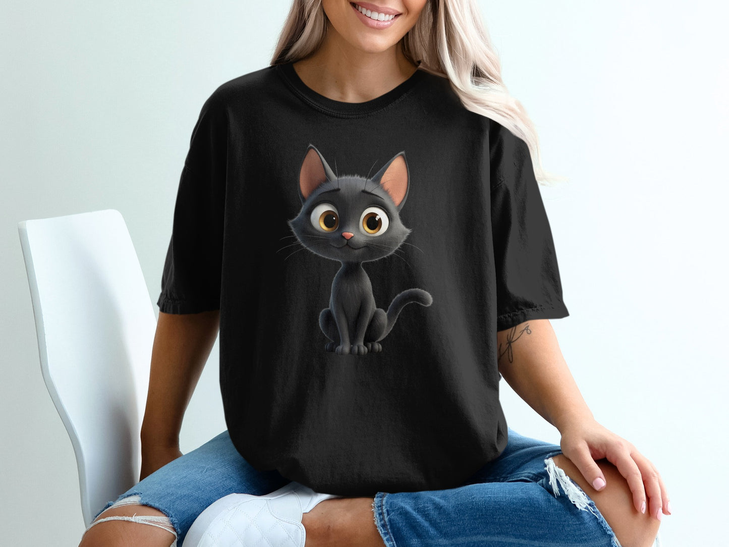 Black t-shirt with a cartoon black cat wearing a yellow collar.