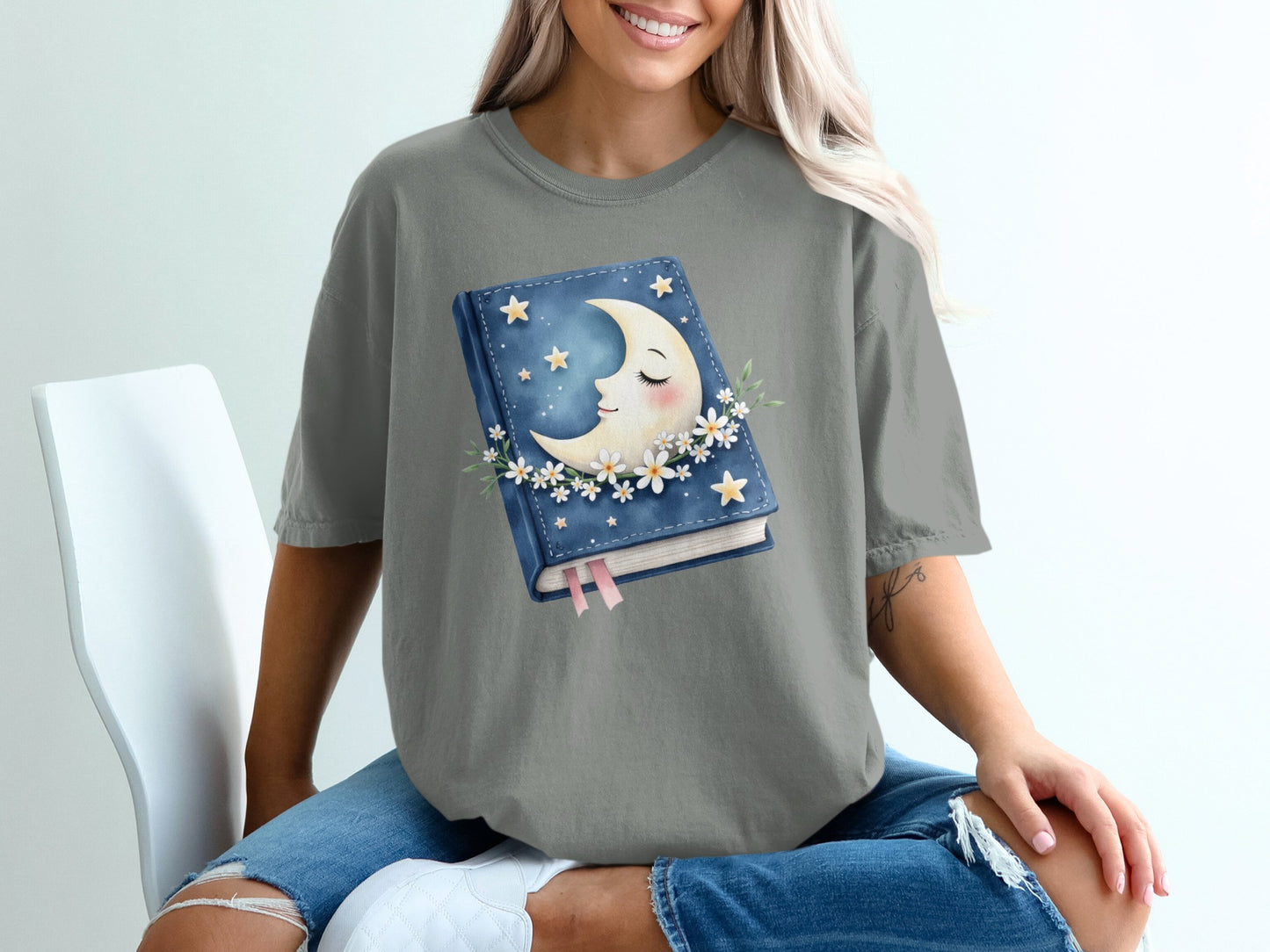 Book with moon and stars design, surrounded by daisies.