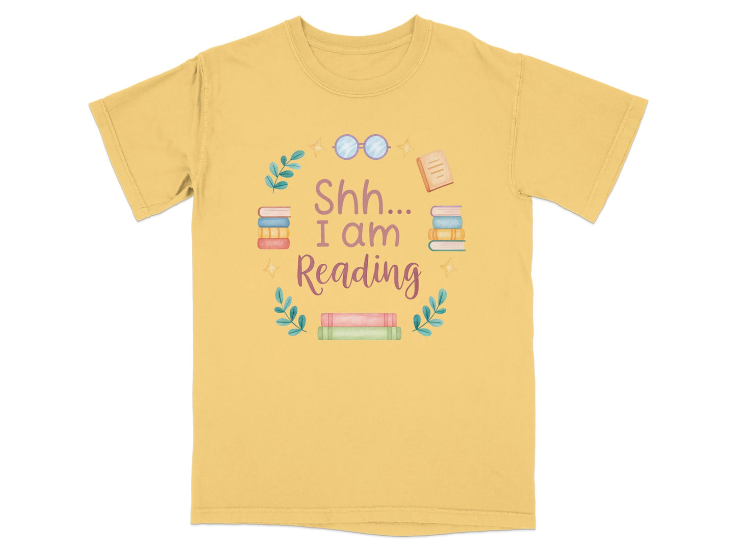 Yellow t-shirt with "Shh... I am Reading" text and stacked books illustration.