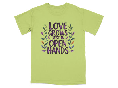 Light green t-shirt with "LOVE GROWS BEST IN OPEN HANDS" text and floral design.